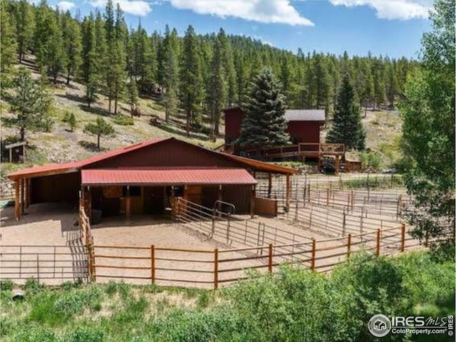 7127 Coal Creek Canyon Hwy, Nederland, CO 80466 - horse barn featuring a wooded view