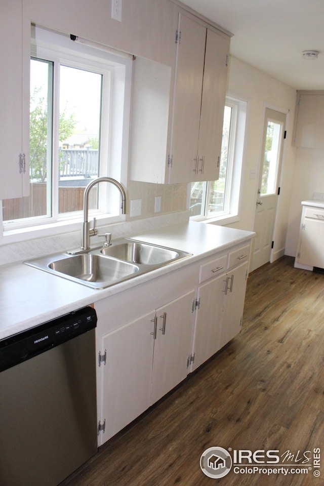 817 Warner St, Fort Morgan, CO 80701 - kitchen with a sink, white cabinets, stainless steel dishwasher, dark wood-type flooring, and light countertops
