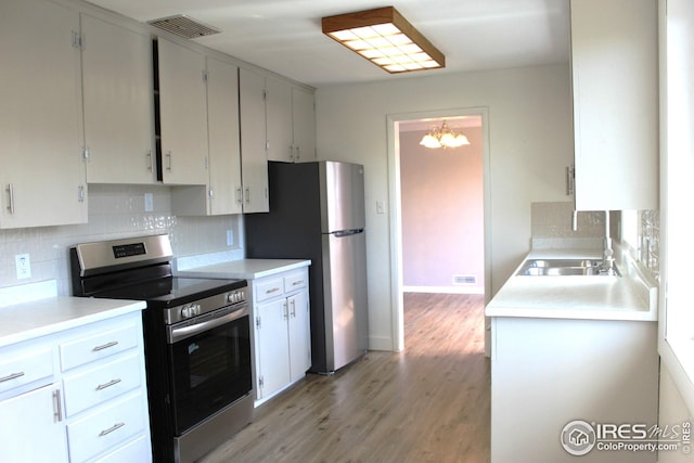 817 Warner St, Fort Morgan, CO 80701 - kitchen featuring an inviting chandelier, a sink, visible vents, appliances with stainless steel finishes, and tasteful backsplash