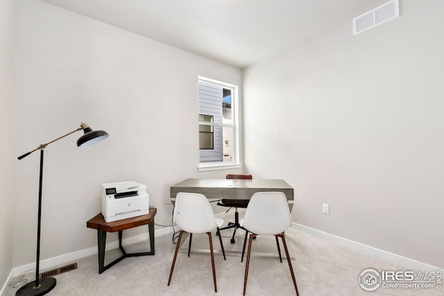 dining area with baseboards, visible vents, and light colored carpet