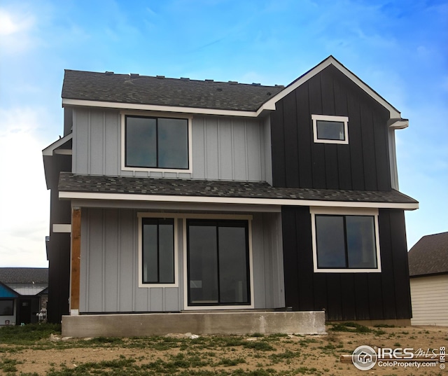 view of front facade with a shingled roof and board and batten siding
