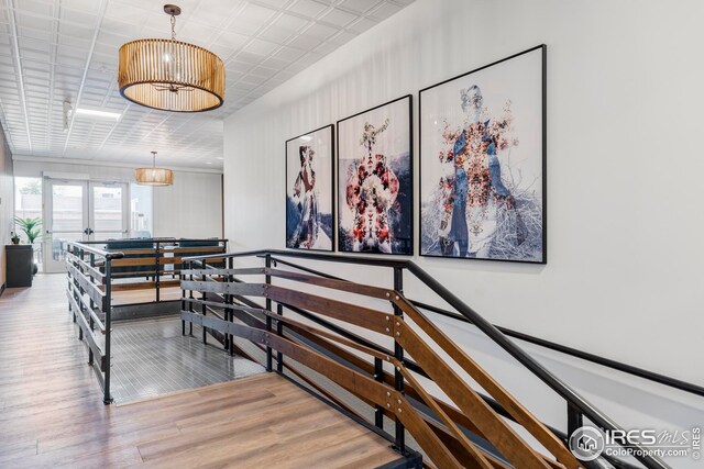 1707 Walnut St Unit 210, Boulder, CO 80302 - staircase featuring wood finished floors, a chandelier, and french doors