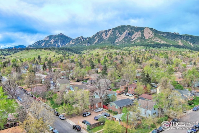 view of property location with a mountain backdrop and nearby suburban area