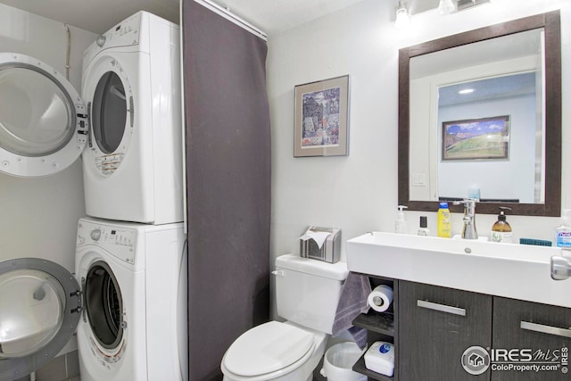 750 W Moorhead Cir Unit A, Boulder, CO 80305 - bathroom with stacked washing machine and dryer, toilet, and a sink