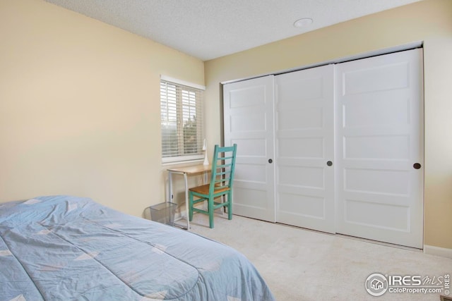 750 W Moorhead Cir Unit A, Boulder, CO 80305 - bedroom with carpet flooring, a textured ceiling, a closet, and baseboards
