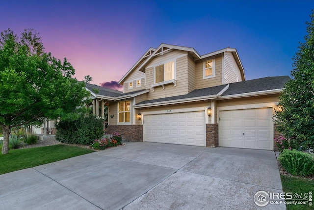 5433 Wishing Well Dr, Timnath, CO 80547 - view of front of home featuring concrete driveway, a garage, stone siding, and a lawn