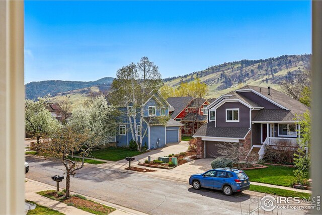 4856 10th St, Boulder, CO 80304 - view of front of home with concrete driveway, a mountain view, and an attached garage