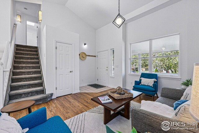 4856 10th St, Boulder, CO 80304 - living room with stairs, wood finished floors, high vaulted ceiling, and baseboards