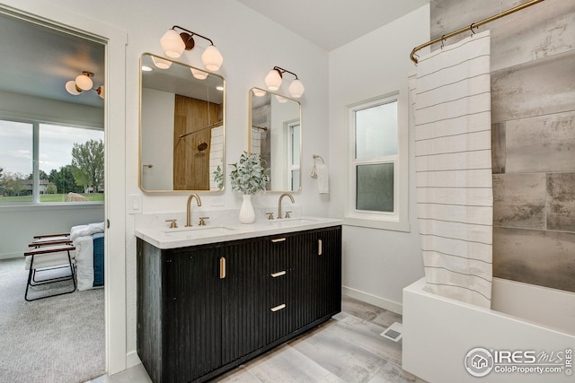full bathroom with baseboards, double vanity, shower / bath combo with shower curtain, and wood finished floors