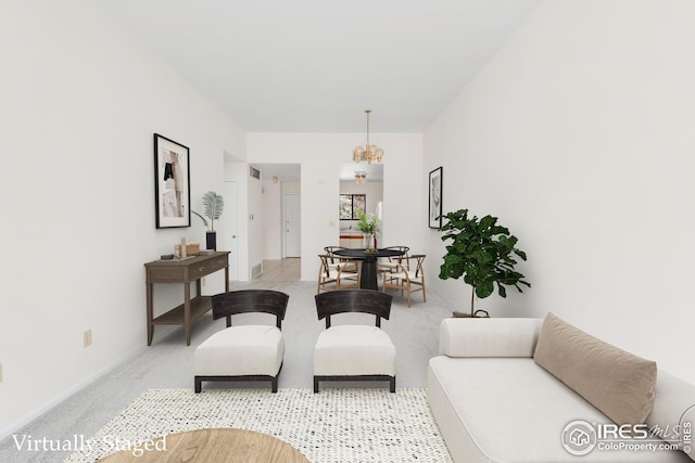 living area with light carpet, baseboards, and a chandelier