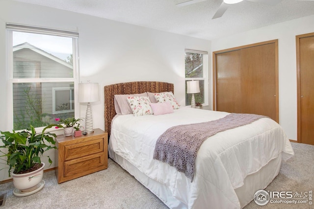 3821 Howe Ct, Boulder, CO 80301 - bedroom with light carpet, multiple closets, and a ceiling fan