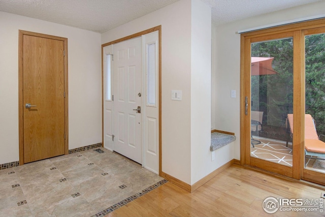 3821 Howe Ct, Boulder, CO 80301 - entrance foyer with light wood-type flooring, a textured ceiling, and baseboards