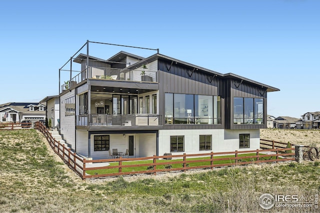 back of house featuring a balcony