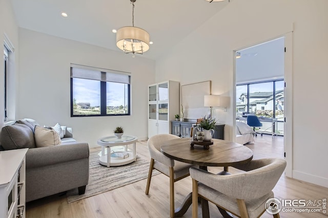 dining space with light wood finished floors, a chandelier, recessed lighting, and baseboards