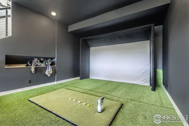 recreation room with carpet floors and golf simulator