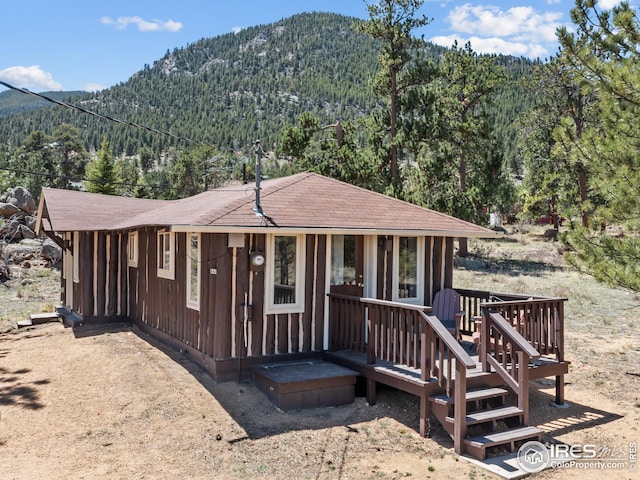 view of front facade featuring a mountain view and a wooded view