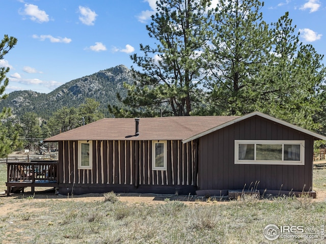 view of front of property with a deck with mountain view