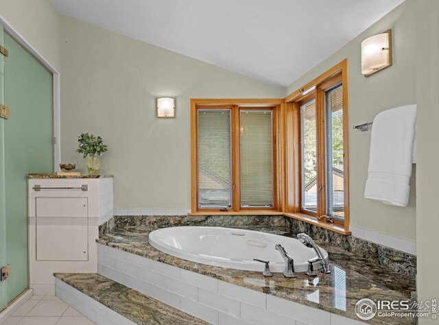 560 Northstar Ct, Boulder, CO 80304 - full bathroom featuring lofted ceiling, a stall shower, a garden tub, tile patterned flooring, and baseboards