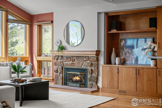 560 Northstar Ct, Boulder, CO 80304 - living room featuring wood finished floors, lofted ceiling, and a stone fireplace