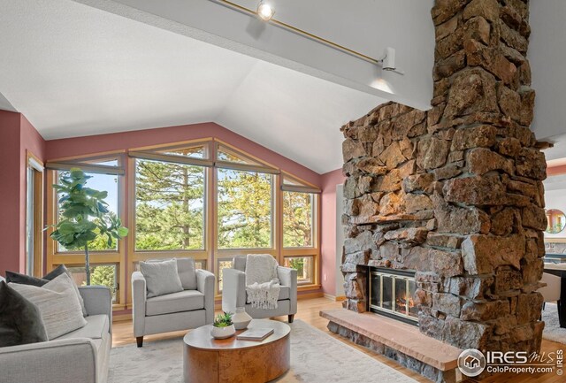 560 Northstar Ct, Boulder, CO 80304 - living area featuring vaulted ceiling, light wood-type flooring, and a fireplace