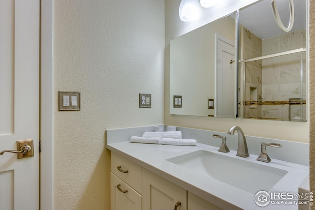 6300 Feldspar Ct, Bellvue, CO 80512 - bathroom with a stall shower, vanity, and a textured wall