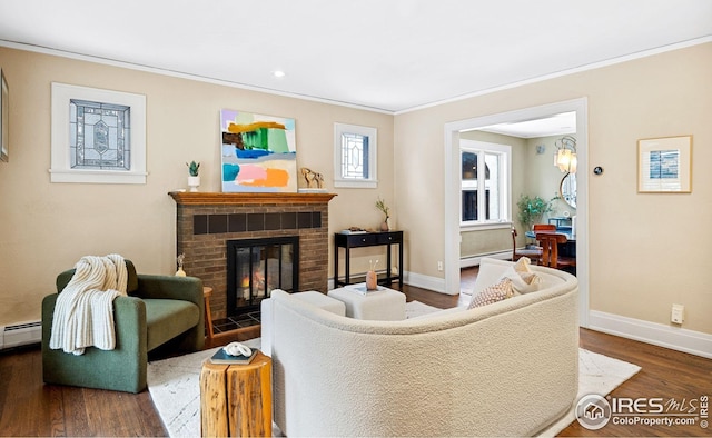 229 Albion St, Denver, CO 80220 - living area featuring baseboards, wood finished floors, crown molding, a brick fireplace, and a baseboard radiator