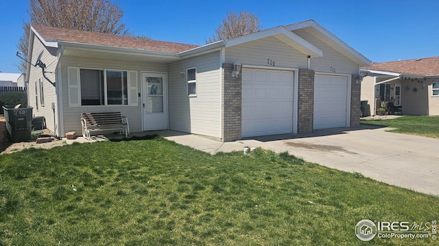 ranch-style home with an attached garage, concrete driveway, a front yard, and brick siding