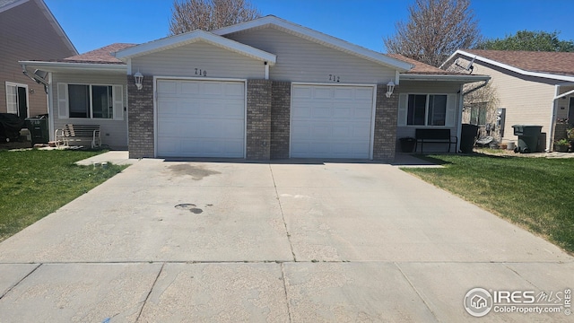 ranch-style house with an attached garage, concrete driveway, a front lawn, and brick siding