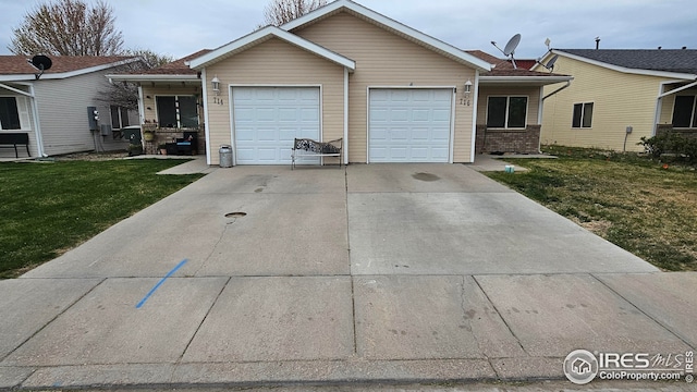 ranch-style house featuring concrete driveway, a front yard, and an attached garage