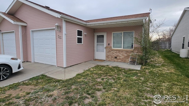 view of front of house featuring an attached garage and brick siding