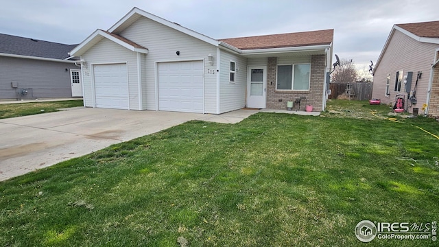 view of front of property featuring an attached garage, concrete driveway, brick siding, and a front lawn