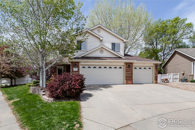 1108 Basin Ct, Windsor, CO 80550 - traditional-style home featuring concrete driveway, brick siding, a garage, and roof with shingles