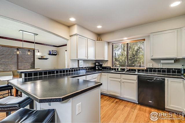 1108 Basin Ct, Windsor, CO 80550 - kitchen featuring dishwasher, a sink, dark countertops, a breakfast bar area, and recessed lighting