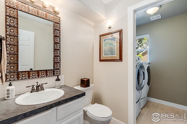1108 Basin Ct, Windsor, CO 80550 - bathroom with toilet, baseboards, vanity, and wood finished floors