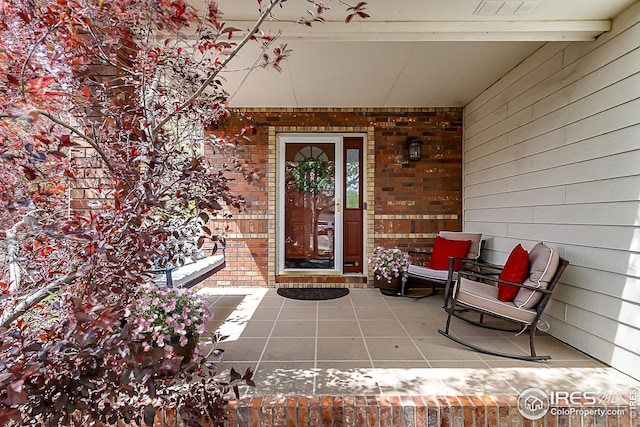 1108 Basin Ct, Windsor, CO 80550 - view of exterior entry featuring a porch and brick siding