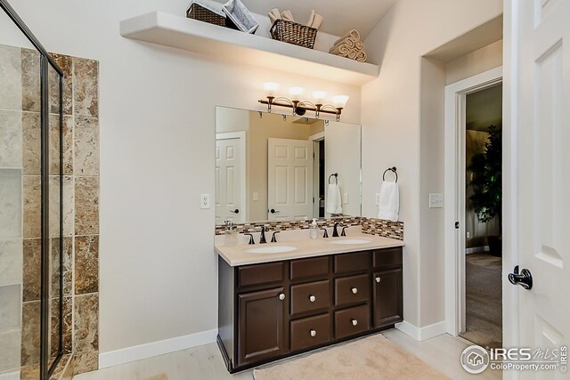1108 Basin Ct, Windsor, CO 80550 - full bath with a stall shower, double vanity, and baseboards