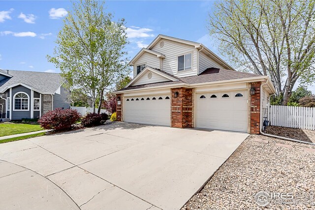 1108 Basin Ct, Windsor, CO 80550 - traditional home featuring brick siding, fence, and driveway