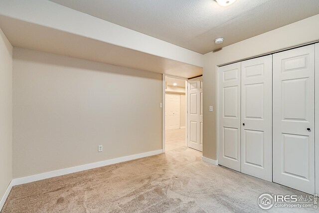 1108 Basin Ct, Windsor, CO 80550 - unfurnished bedroom featuring light carpet, baseboards, and a closet