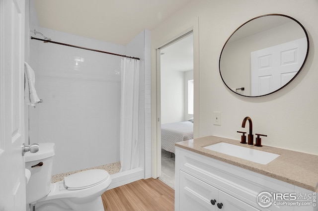 bathroom featuring wood finished floors, toilet, vanity, and a shower with curtain