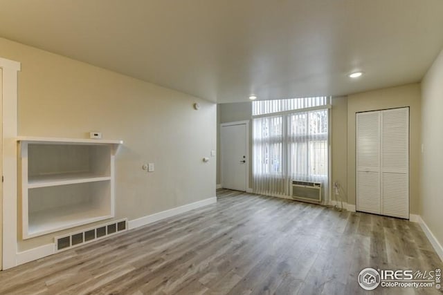 3460 Madison Ave, Boulder, CO 80303 - unfurnished living room with baseboards, wood finished floors, a wall mounted AC, and recessed lighting