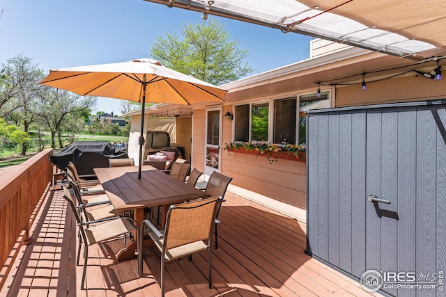 wooden terrace featuring outdoor dining area