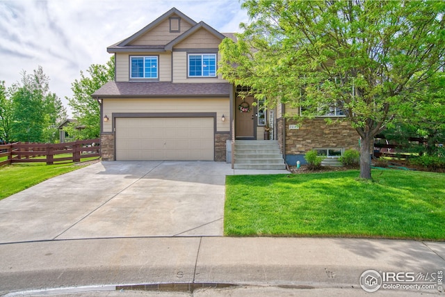 2069 Vineyard Ct, Windsor, CO 80550 - view of front of property with driveway, an attached garage, and stone siding
