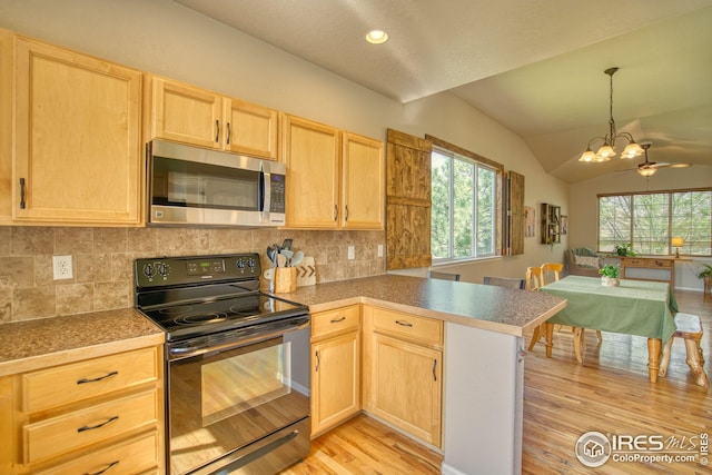 2069 Vineyard Ct, Windsor, CO 80550 - kitchen with stainless steel microwave, black range with electric stovetop, light brown cabinets, light wood-style floors, and lofted ceiling