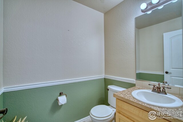 2069 Vineyard Ct, Windsor, CO 80550 - half bath with toilet, vanity, and a textured wall