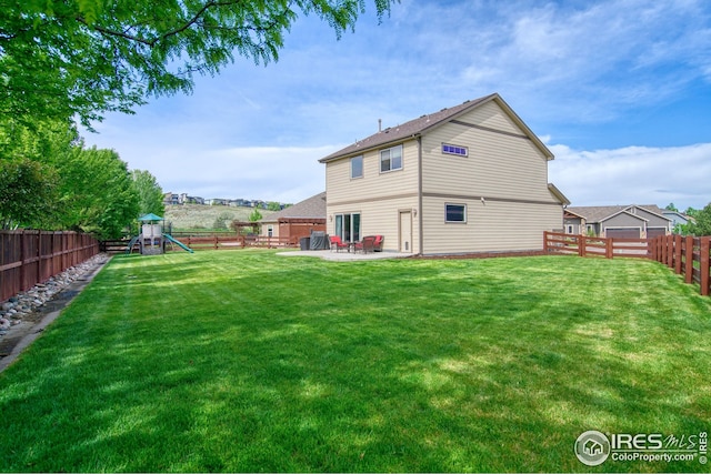 2069 Vineyard Ct, Windsor, CO 80550 - rear view of property featuring a playground and a patio