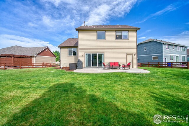 2069 Vineyard Ct, Windsor, CO 80550 - back of property with a patio area and central AC