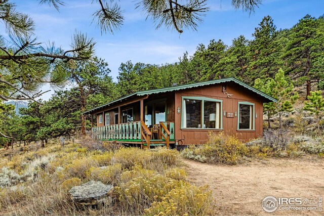 2450 Eagle Cliff Rd, Estes Park, CO 80517 - chalet / cabin featuring a porch
