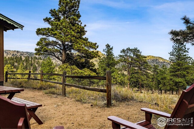 2450 Eagle Cliff Rd, Estes Park, CO 80517 - view of yard featuring fence and a wooded view