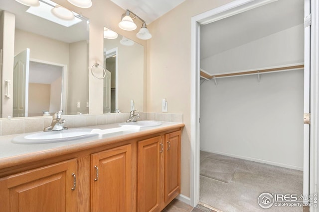 955 Sunchase Dr, Fort Collins, CO 80524 - full bath with double vanity, a spacious closet, and baseboards