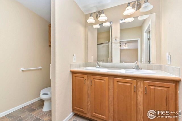 955 Sunchase Dr, Fort Collins, CO 80524 - full bath with double vanity, toilet, and baseboards